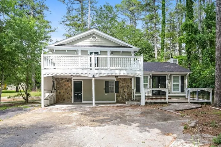 Exterior featuring a two-story design with siding and stone accents