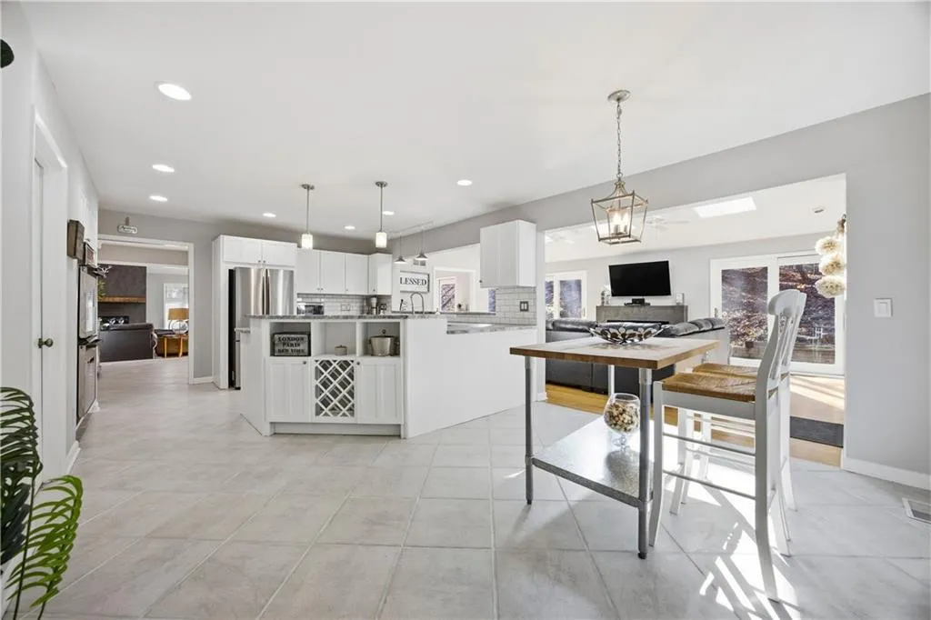 Bright eat-in kitchen with modern lighting and seamless flow to dining and living spaces