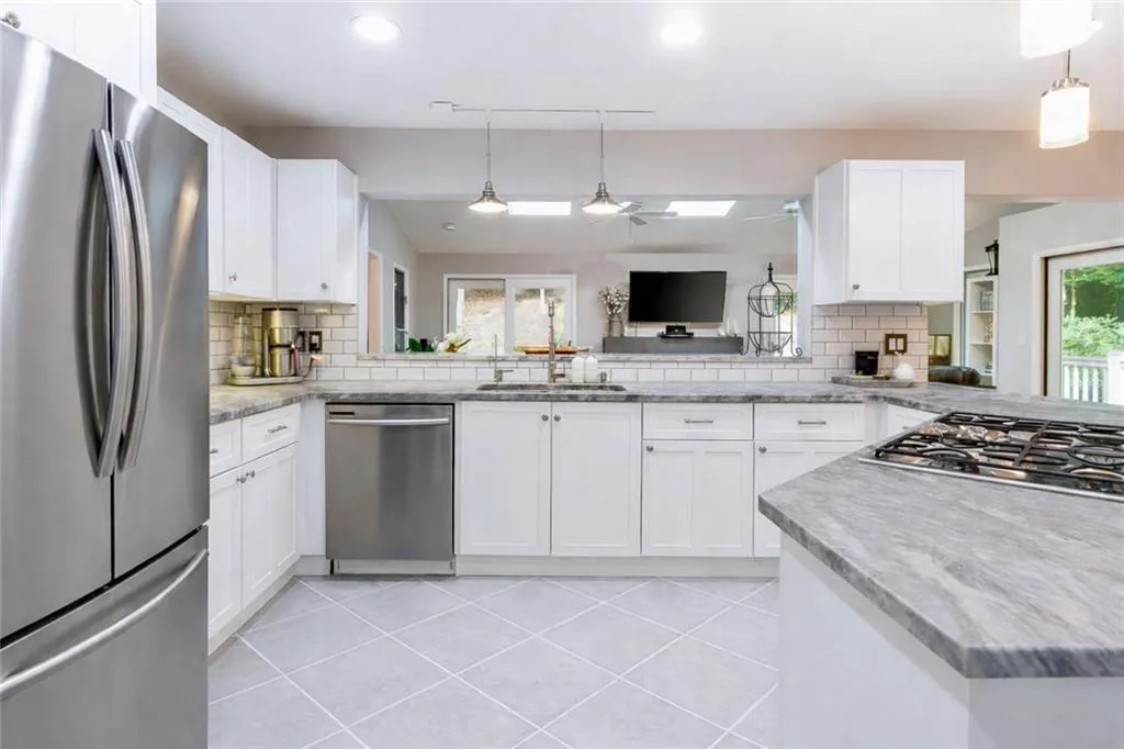 Chef’s kitchen featuring gas cooktop, double ovens, and abundant cabinet storage