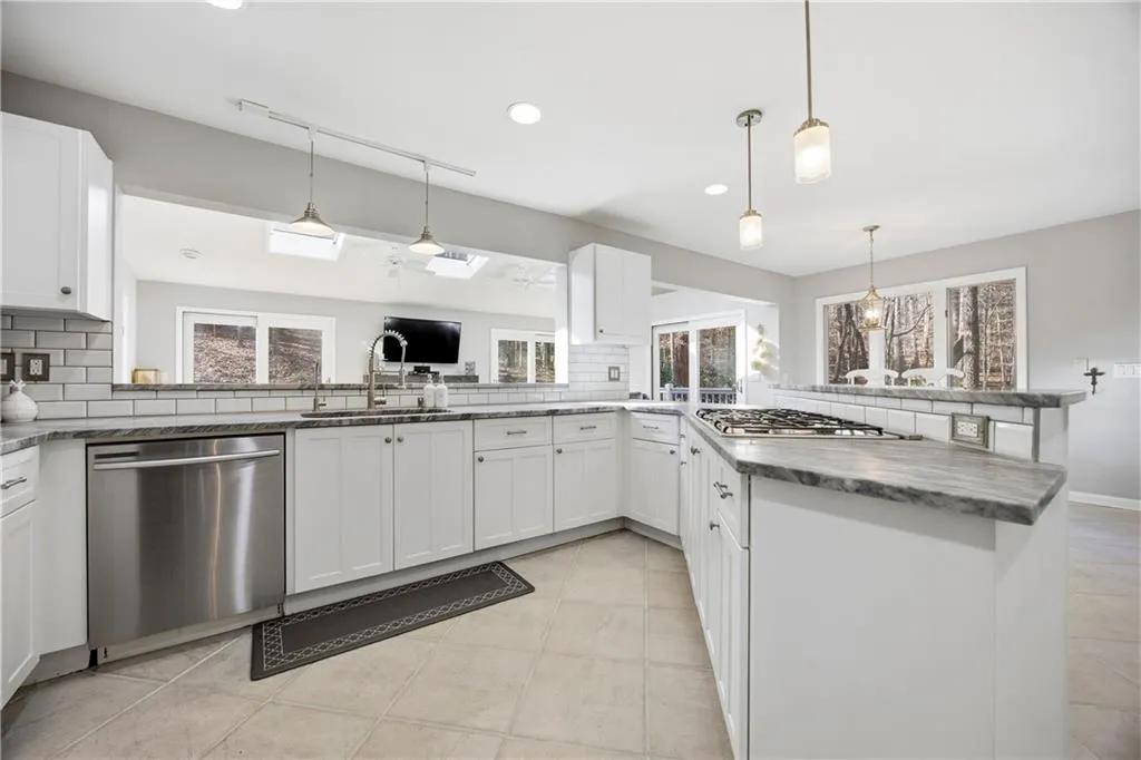 Chef’s kitchen featuring gas cooktop, double ovens, and abundant cabinet storage