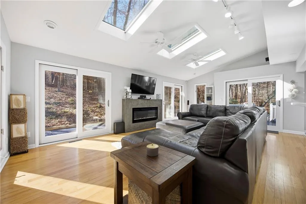 Family room with three skylights right off the kitchen overlooks the serene backyard