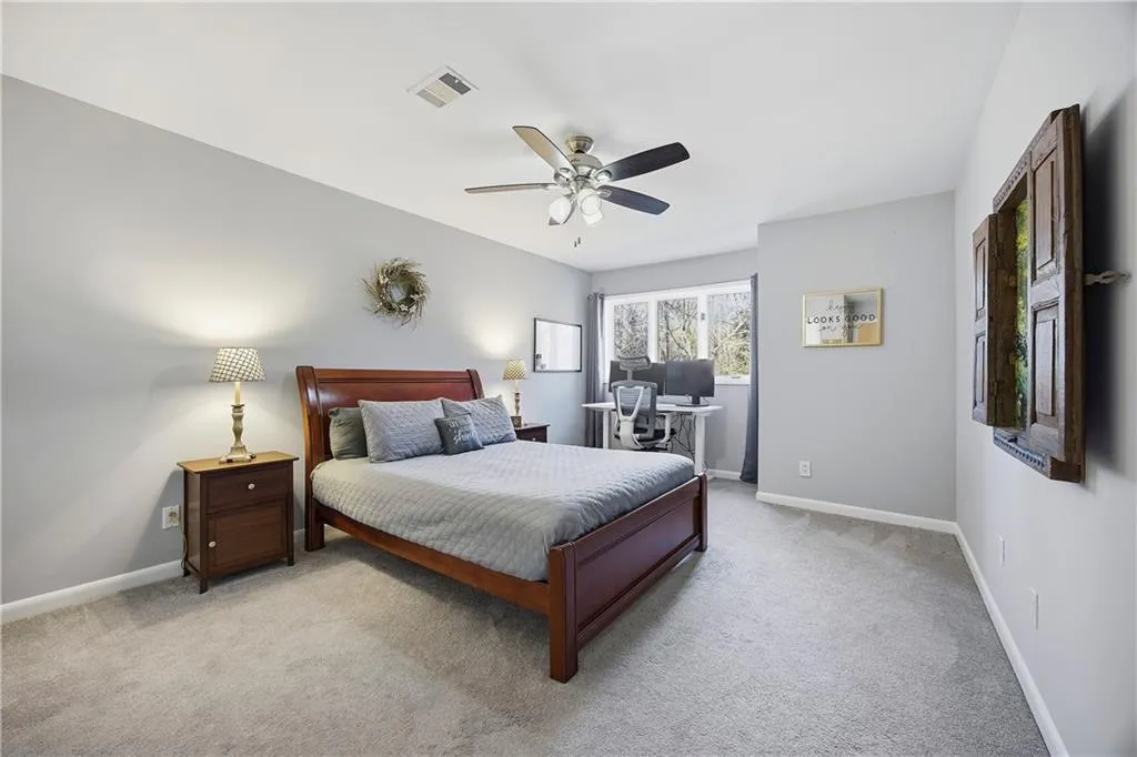 Spacious third bedroom upstairs with alcove made for working from home while overlooking nature