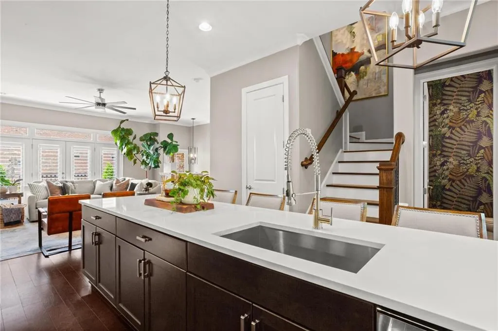 The oversized stainless undersmount sink is complimented by the upgraded light fixtures which act as jewelry in the space