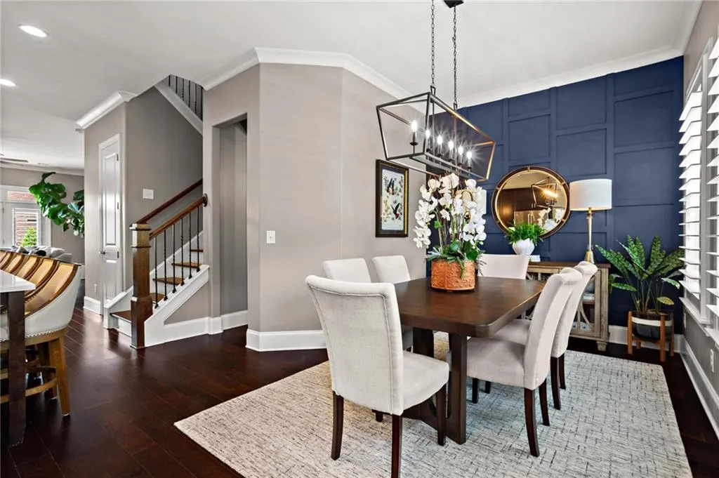 The upgrades continue in the dining room with the navy accent wall and the linear lantern chandelier which accentuates the size of the dining room area just waiting for you to host your next dinner party