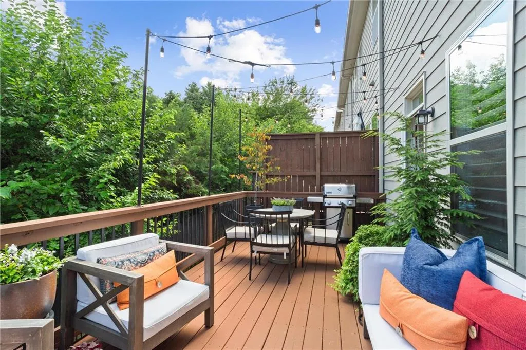 The spacious back patio offers space for both dining and a seating area  extending your living space
