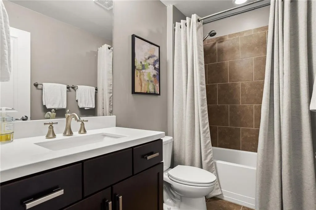 Secondary bathroom upstairs is directly adjacent to the upstairs bedrooms and features tub/shower combo with tile surround