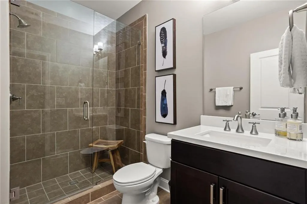 Secondary terrace level bathroom offers a frameless shower