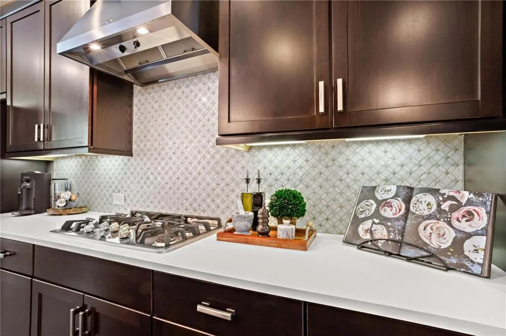 Upgraded Marble backsplash creates an elevated feel in this beautiful kitchen