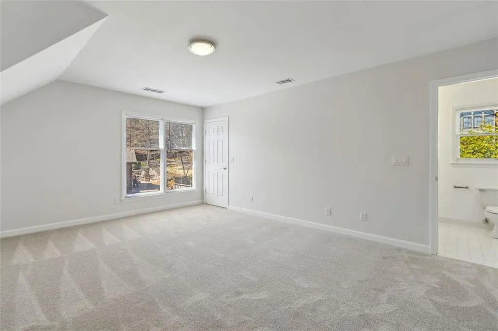 Notice the adjoining ensuite bath and rear stairs entry next to window.
