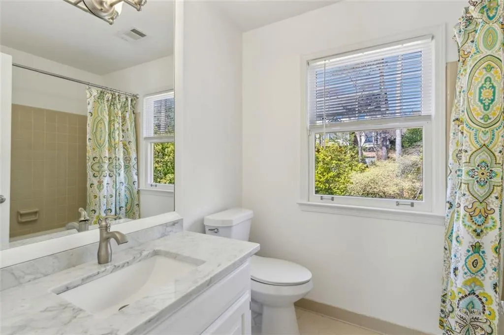 Hall bath with carrara marble vanity and newly refinishe tub