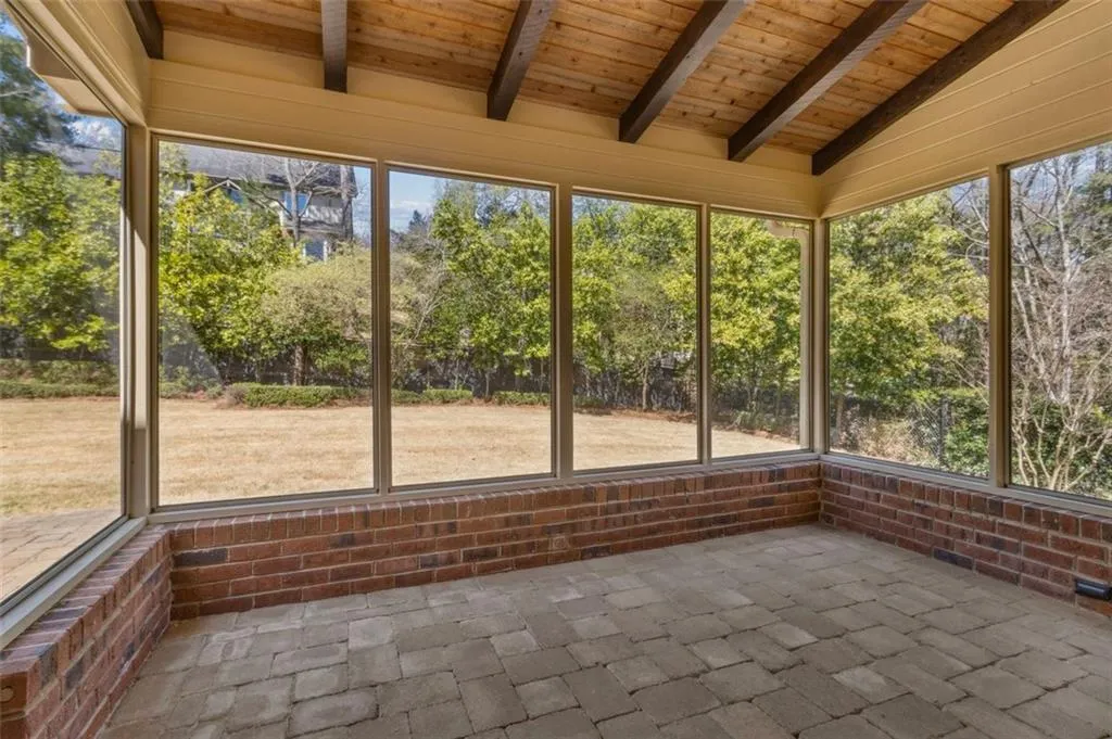 Screened in back patio porch with hand laid stone floor - notice the tongue and groove ceiling with overhead fan