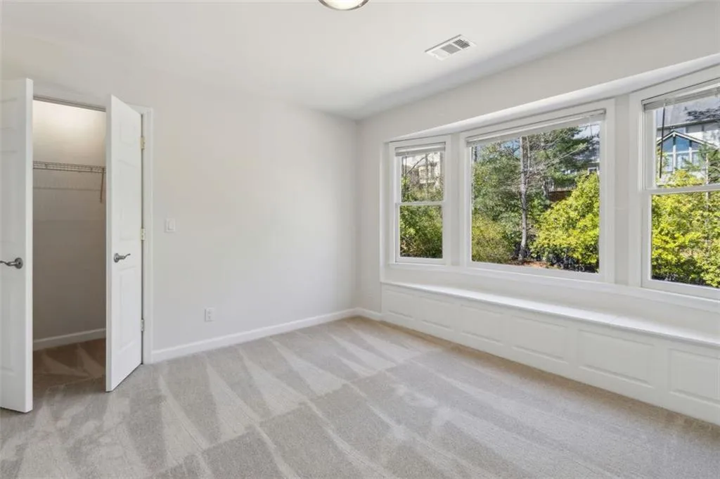 Gorgeous bay window view and seating cabinetry overlooking the backyard