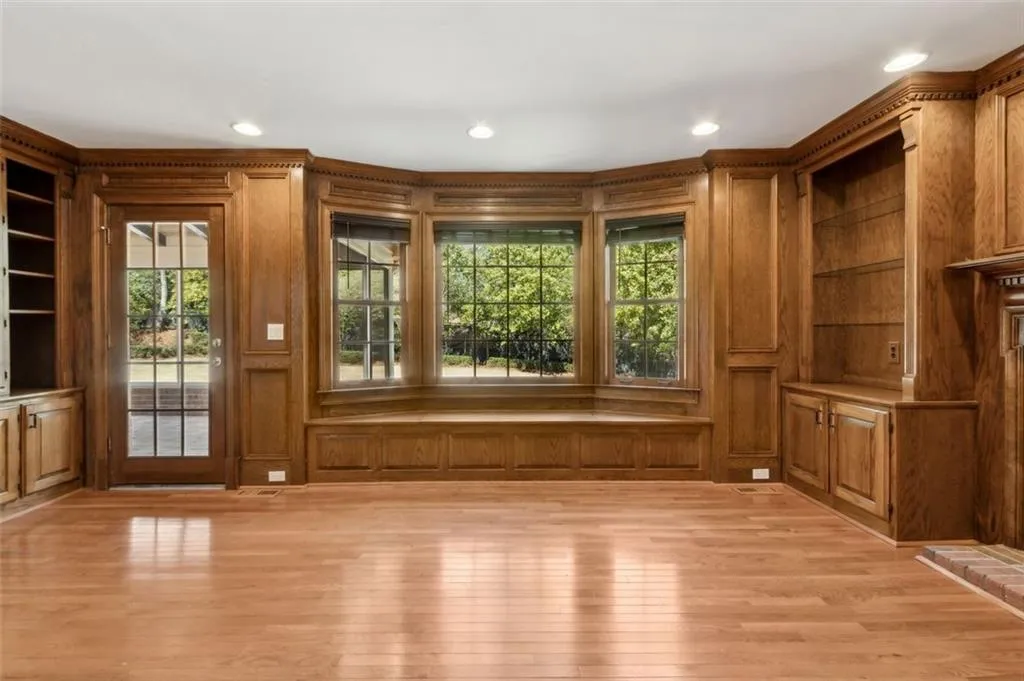 Family room overlooks the beautiful level backyard with entry through the sunporch