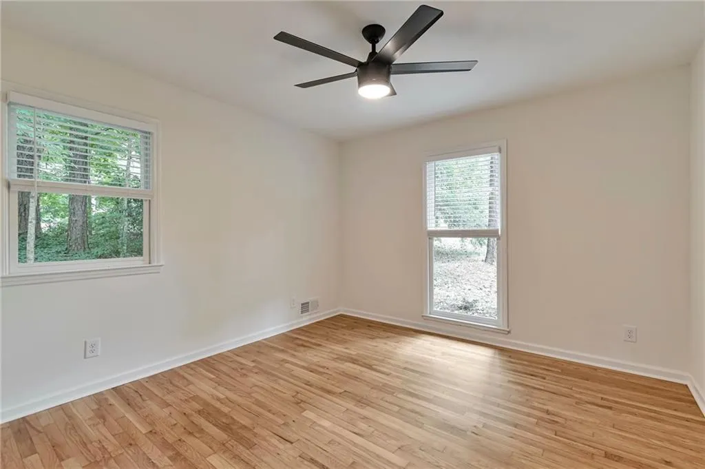 Unfurnished room featuring light wood-type flooring and ceiling fan