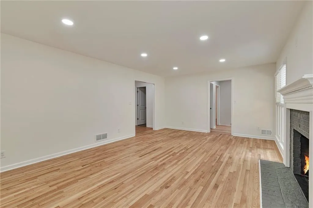 Unfurnished living room with light hardwood / wood-style flooring and a fireplace