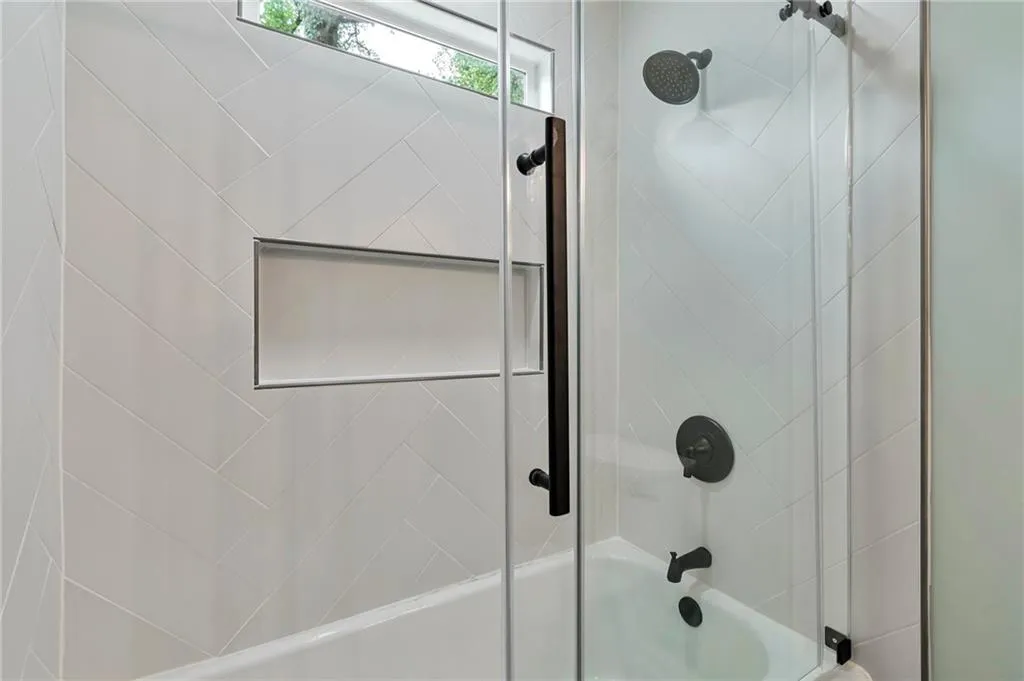 Bathroom featuring enclosed tub / shower combo