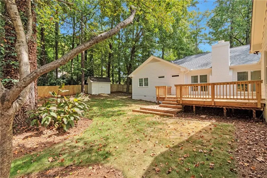 View of yard featuring a storage shed and a deck