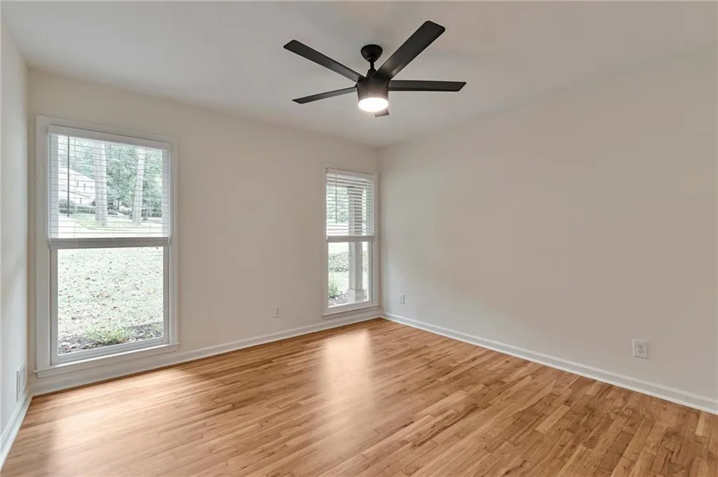 Unfurnished room with ceiling fan and light hardwood / wood-style floors