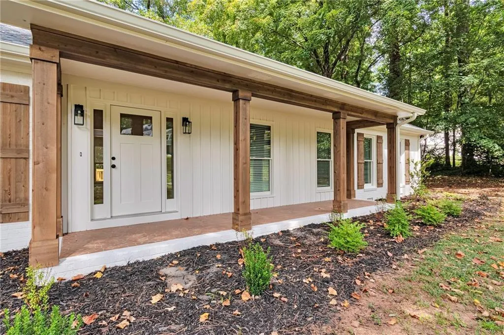 Doorway to property featuring covered porch