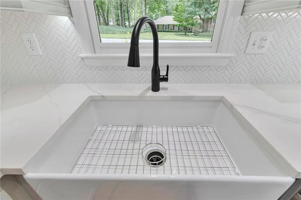 Room details featuring light stone counters and sink
