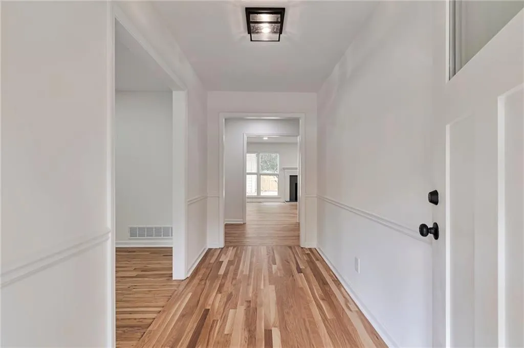 Corridor with light hardwood / wood-style floors