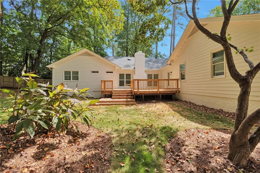 Back of house with a wooden deck