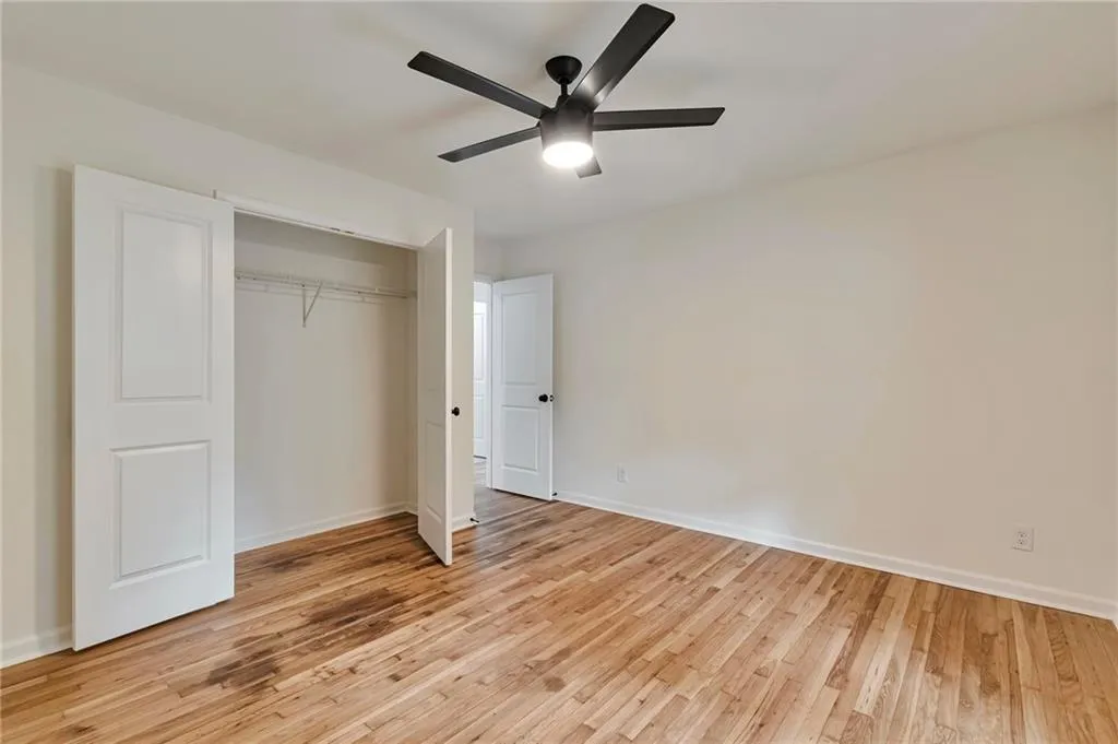 Unfurnished bedroom with light hardwood / wood-style flooring, ceiling fan, and a closet