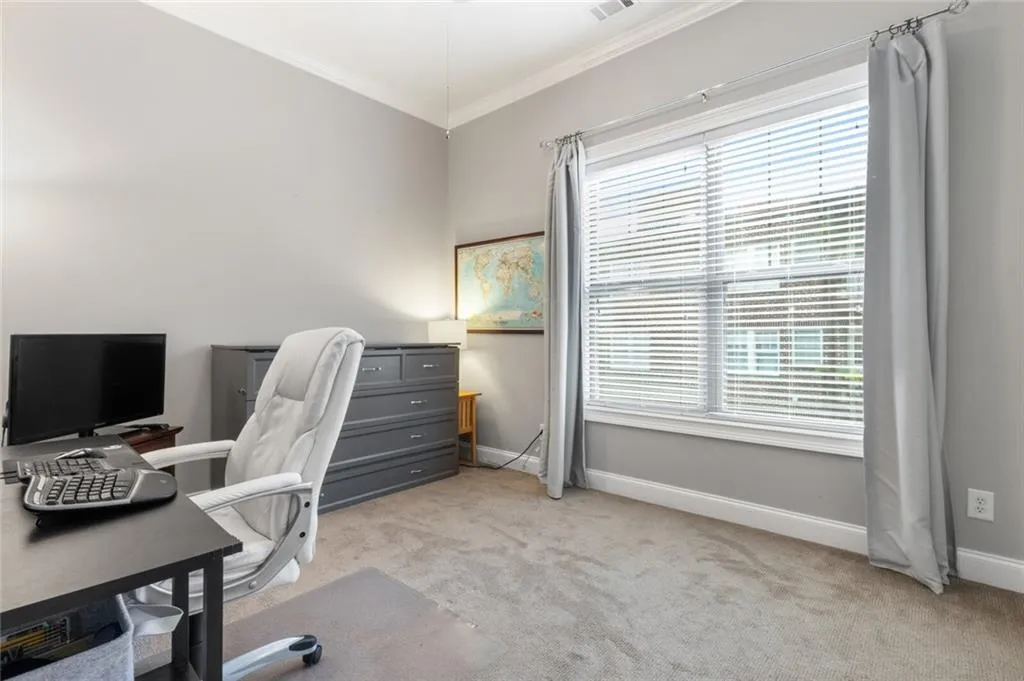 Office with light carpet and ornamental molding