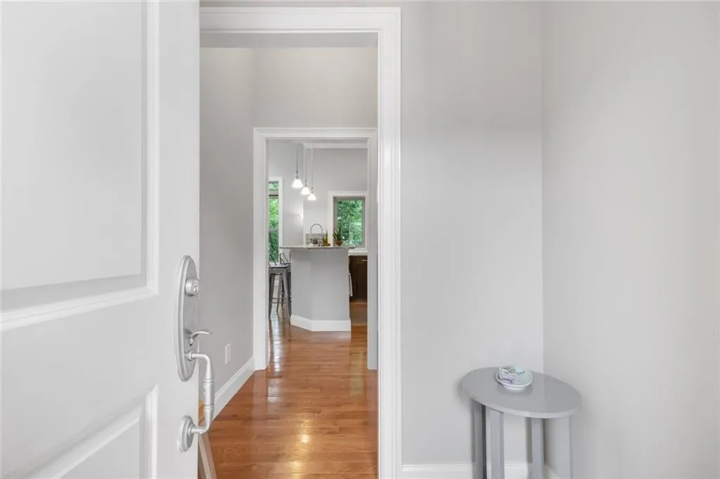Corridor featuring light wood finished floors and baseboards