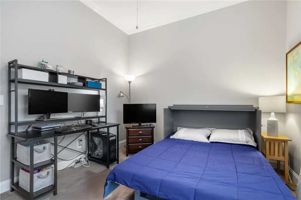 Bedroom featuring carpet and ornamental molding