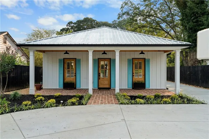 White board-and-batten exterior with a metal roof