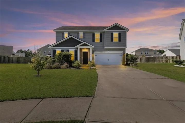 Two-story exterior with gray siding and shingle accents
