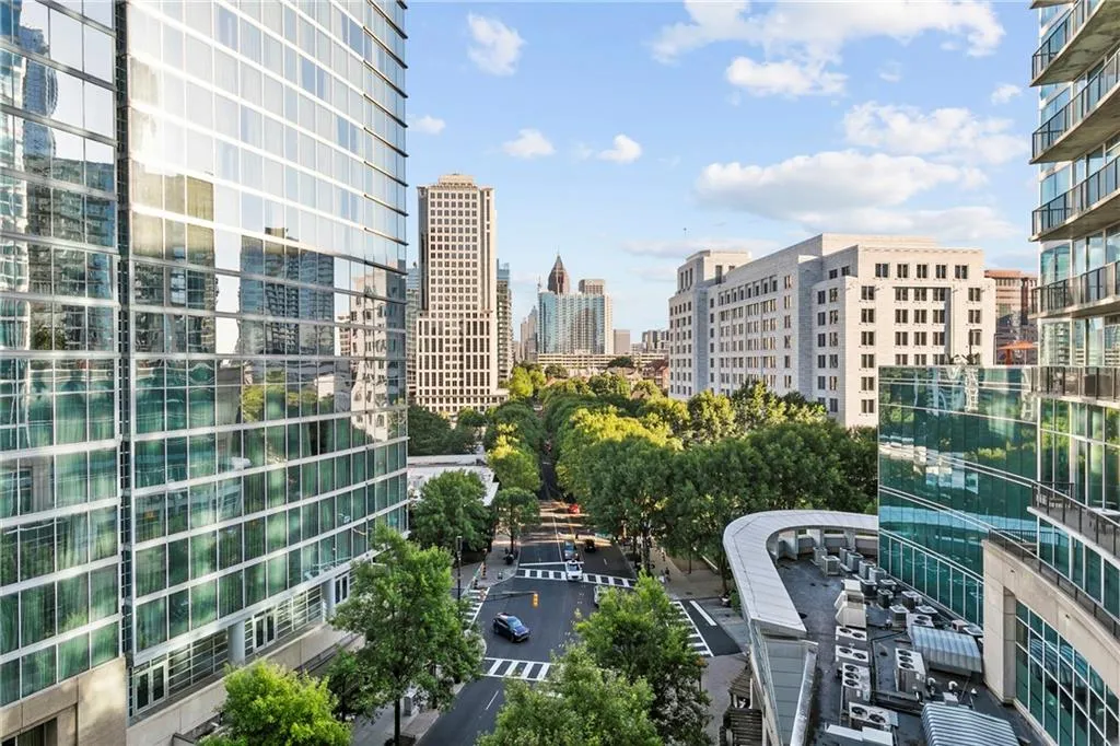 Cityscape with multiple high-rise buildings and tree-lined streets