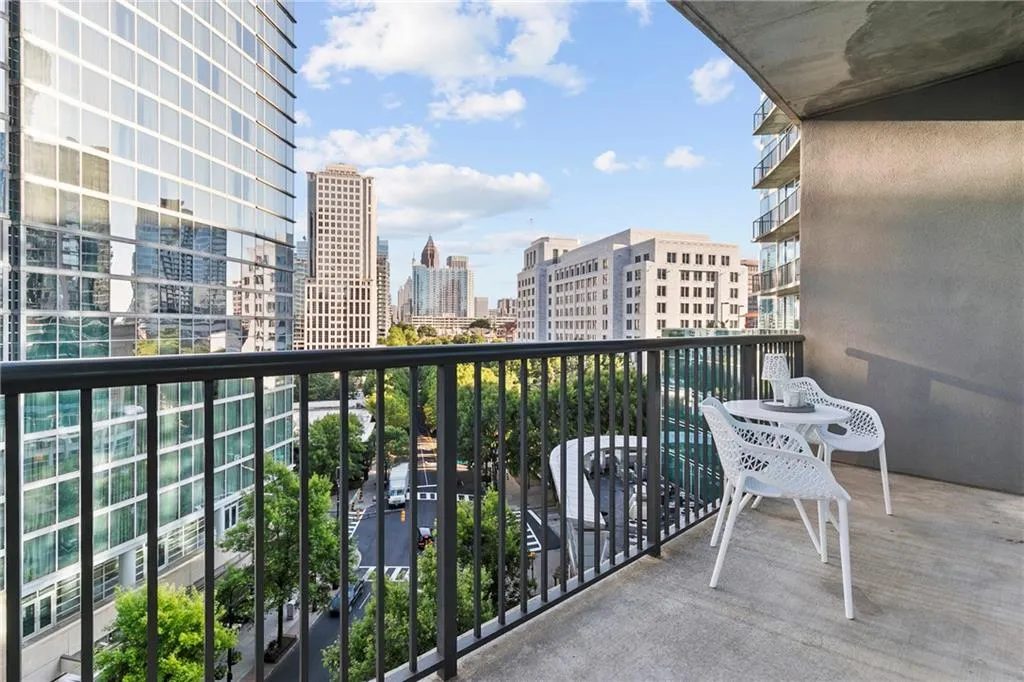 Balcony with concrete flooring and a metal railing