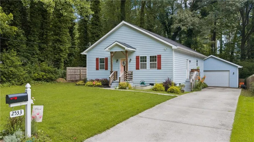 Light blue siding exterior with red window shutters and a covered front entry porch