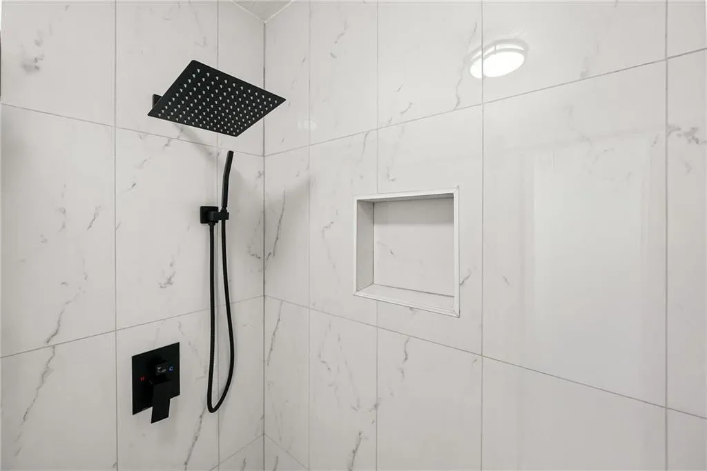 Bathroom view of a marble finish shower