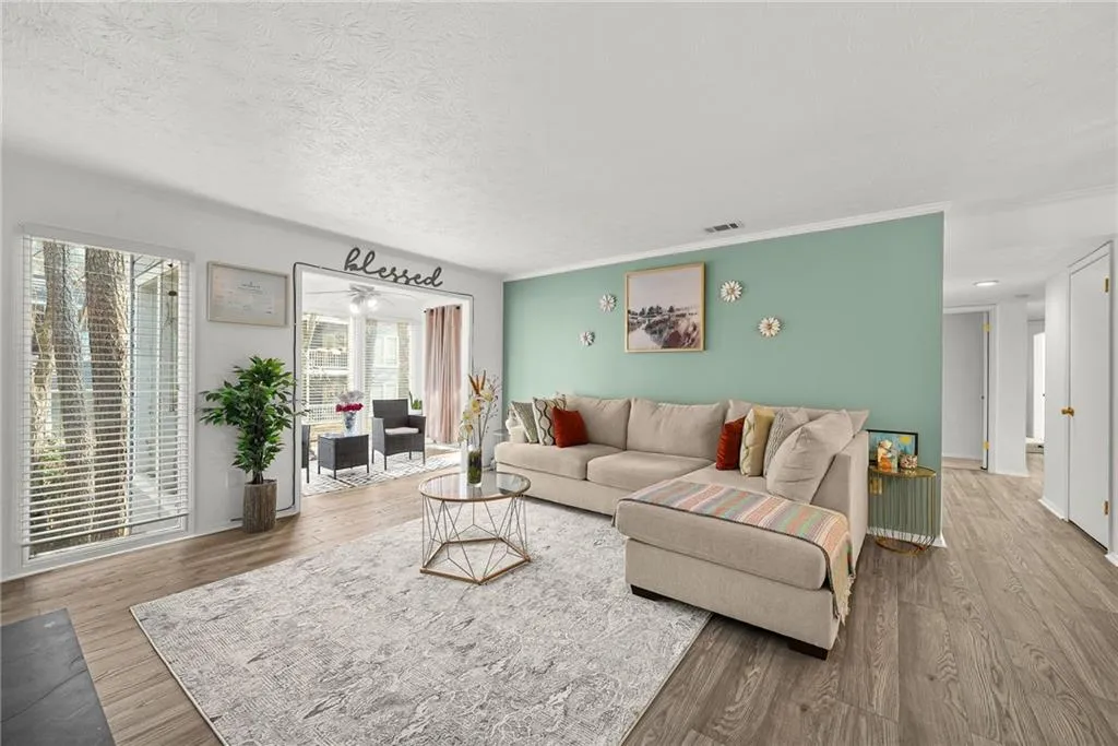 Living room with wood finished floors and a textured ceiling