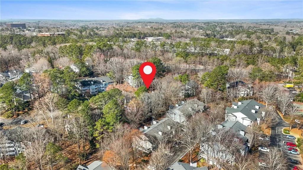Aerial perspective of suburban area featuring a heavily wooded area