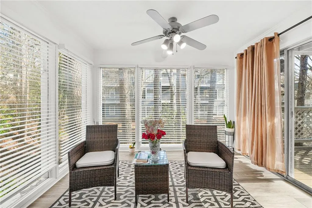 Sunroom / solarium featuring a ceiling fan and a patio