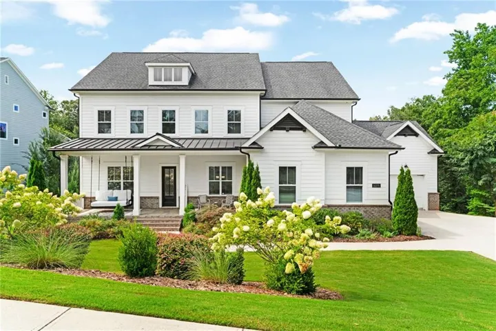 Contemporary white siding residence with a dark asphalt shingle roof