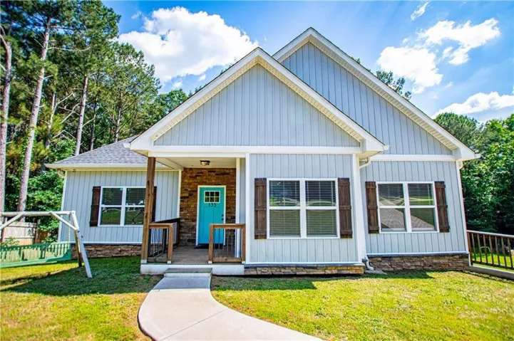 Light blue vertical siding exterior with contrasting stone accents