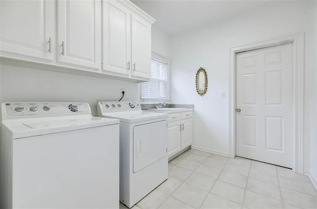 Laundry room with door leading to a walk-in pantry.