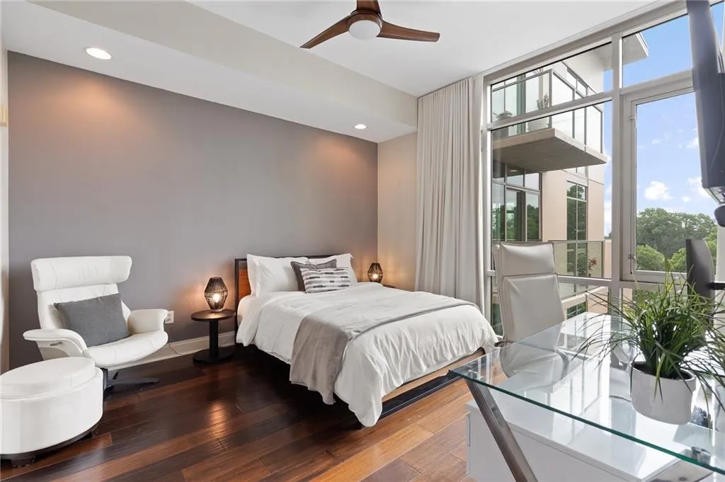 Bedroom with multiple windows, hardwood / wood-style flooring, floor to ceiling windows, ceiling fan, and recessed lighting