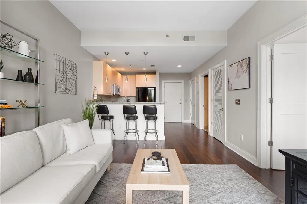 Living room featuring dark wood-style flooring and recessed lighting