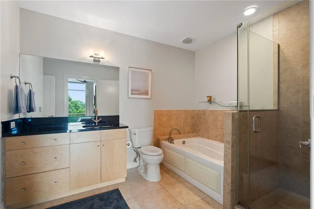 Bathroom with vanity, a bath, a shower stall, and tile patterned floors