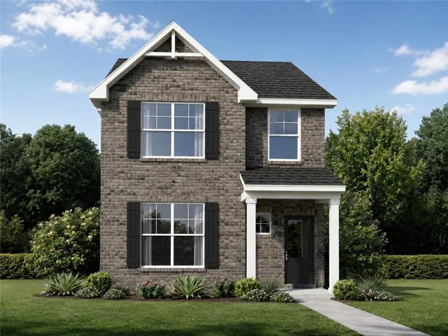 Brick exterior with black shutters, covered front entry, gabled roofline, and established landscaping