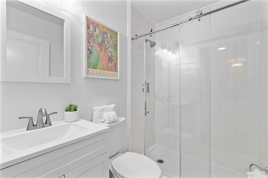 Bathroom featuring a custom shower and vanity