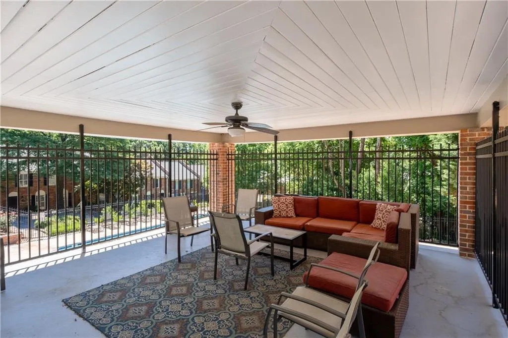 View of patio featuring ceiling fan and an outdoor living space