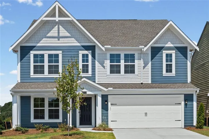 Two-story residence featuring blue horizontal siding and white shake accents