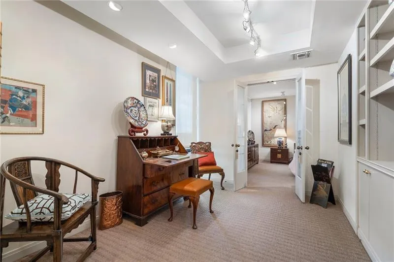 Sitting room featuring baseboards, light colored carpet, visible vents, and track lighting